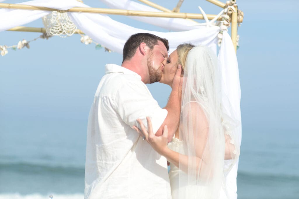 beach arch obstructs wedding kiss